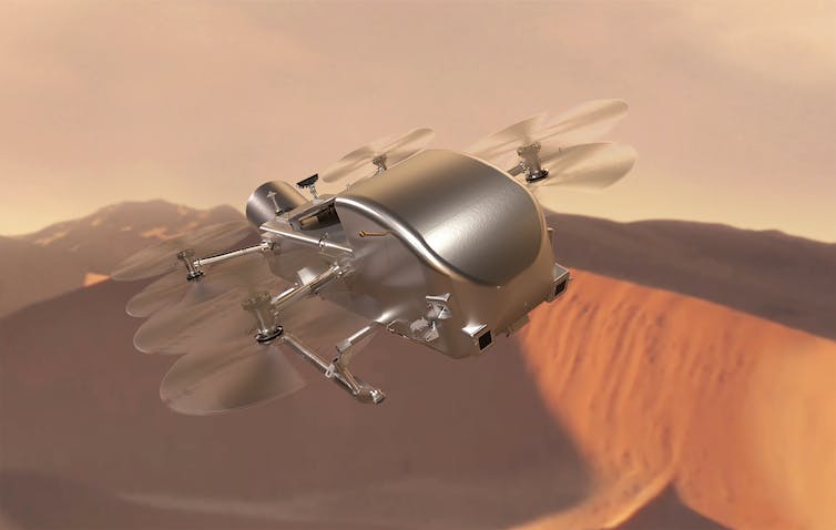 CGI-beeld van een zilveren drone met acht propellers boven het Martiaanse oppervlak